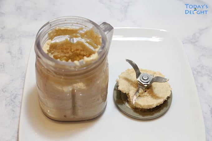 Crushed peanuts in blender container.
