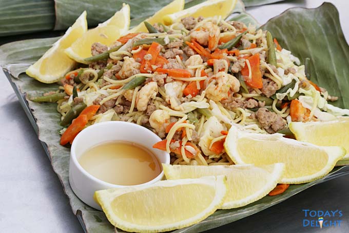 Pancit canton is served in plate lined with banana leaves.