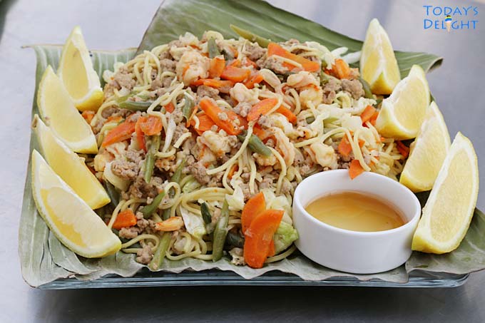 Plated Filipino canton noodles with lemon & fish sauce.