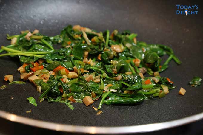 Saute the vegetables and spinach until wilted then set aside.