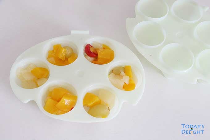 Lower half of Easter egg mold filled with fruit cocktail.