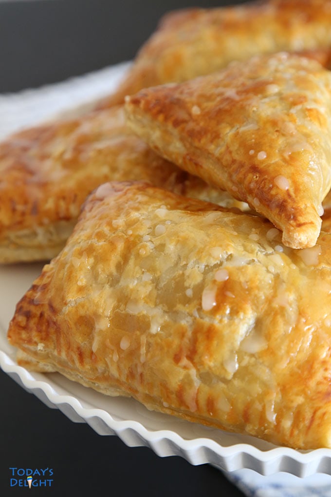 Puff Pastry Apple Turnovers on a cake stand.