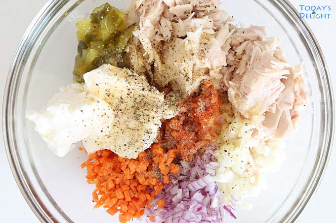 Tuna salad ingredients in bowl.