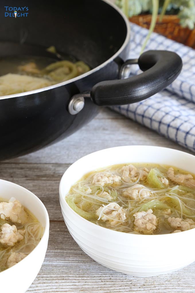 Soup with sponge gourd and miswa noodles in skillet.