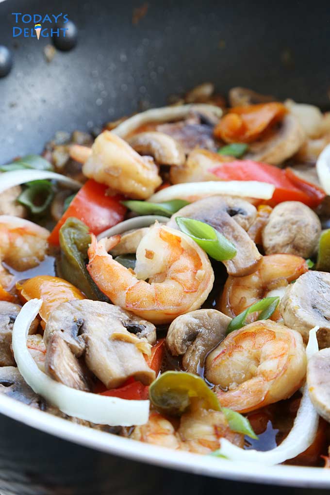Shrimp, mushroom & vegetables in skillet.