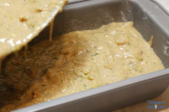Zucchini batter poured half full in pan.
