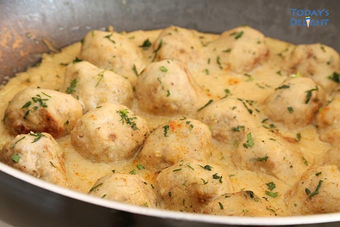 Cooking meatballs in skillet.