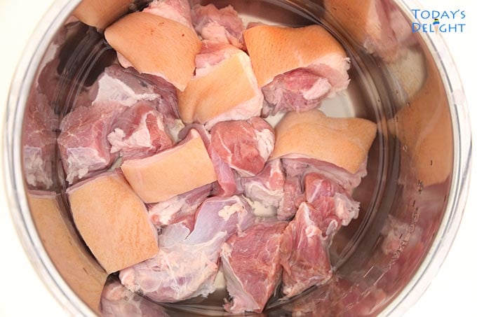 Sliced uncooked pork in instant pot.