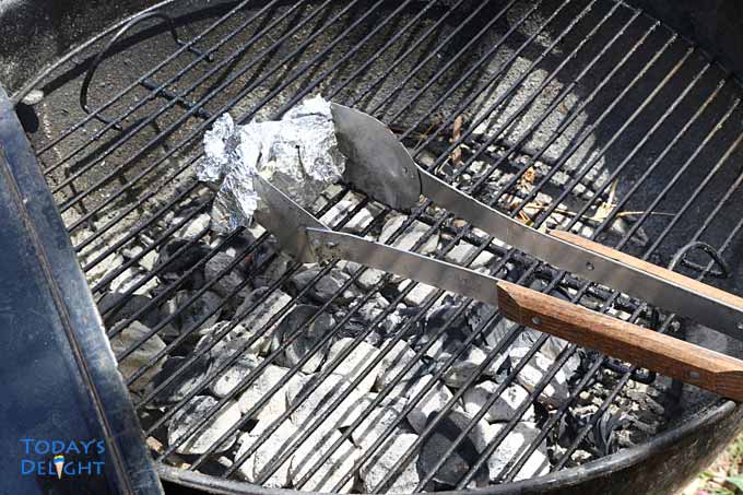 Clean grill with brush or foil.