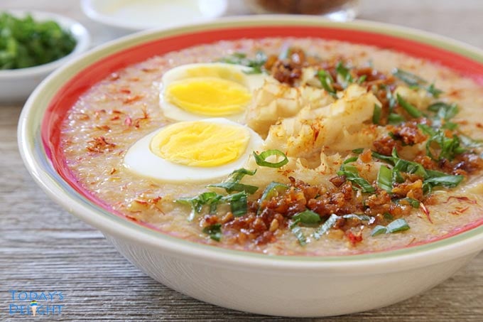 Filipino rice porridge is garnish with other ingredients.