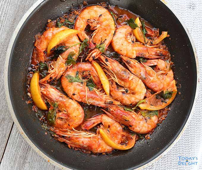 Head-on unpeeled Jamaican peppered shrimp.