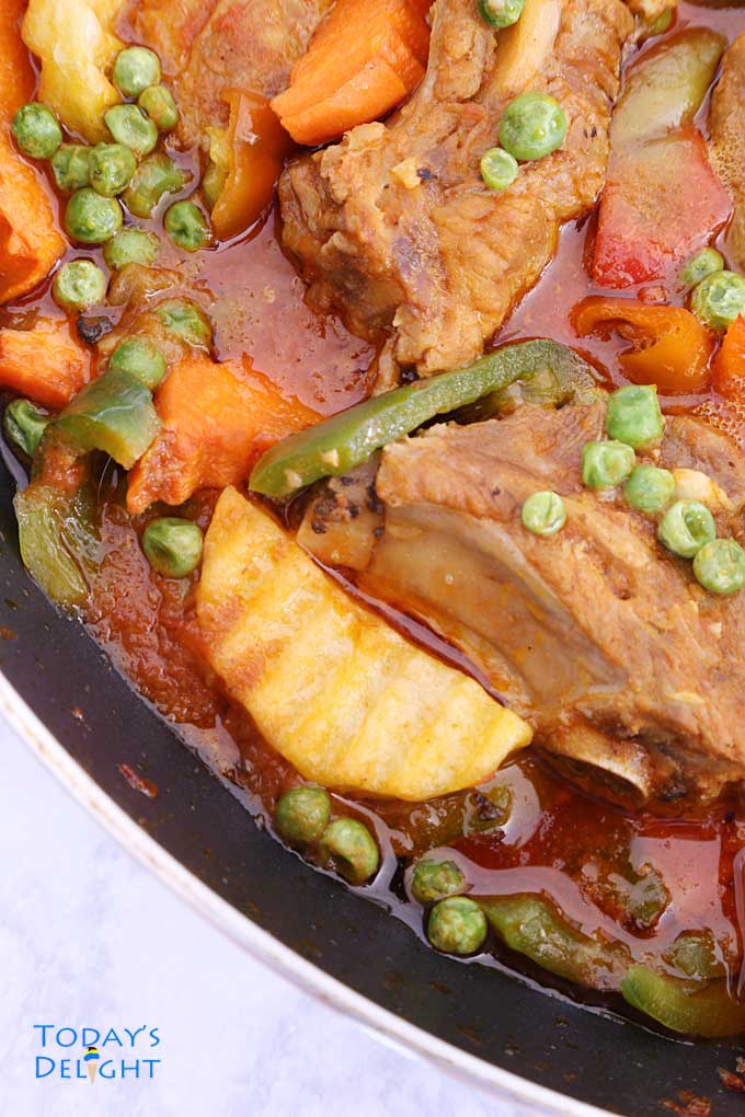 Ribs in tomato base & curry sauce with vegetables.