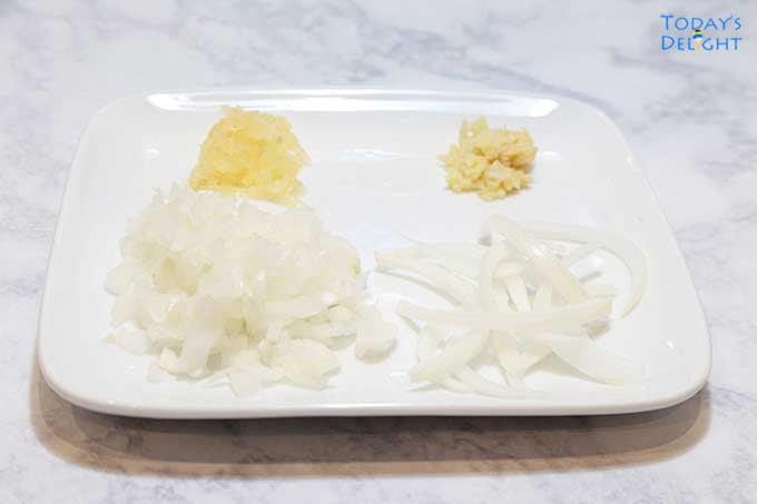 Chopped onion, garlic and ginger in plate.