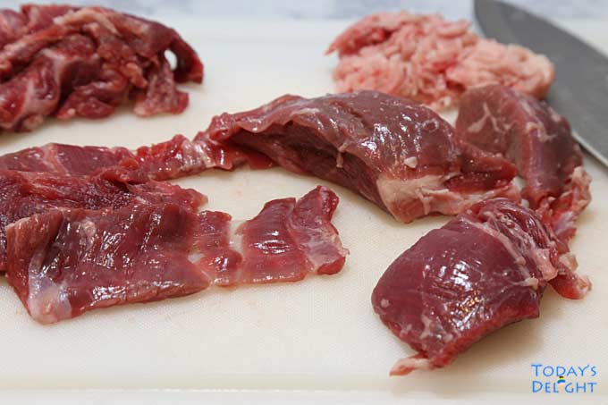 Sliced tri tip steak in a cutting board.