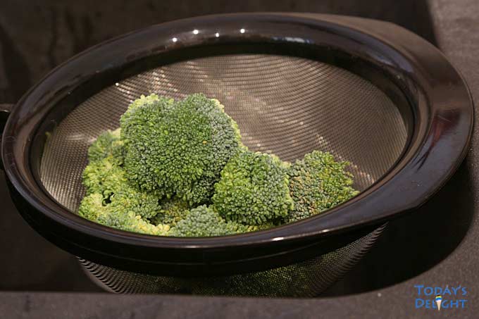 Broccoli washed in a colander.