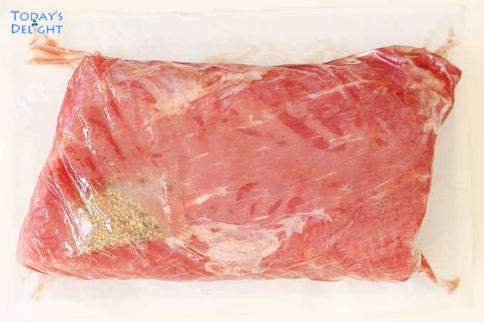 Store-bought uncooked flat cut corned beef brisket with spices.