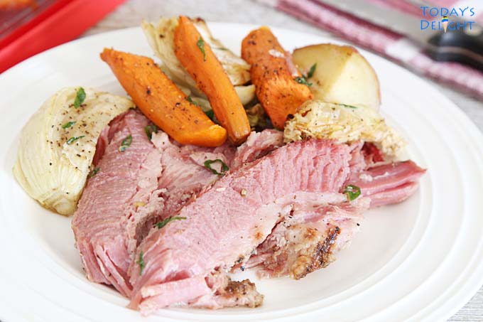 Plated tender corned beef with vegetables.