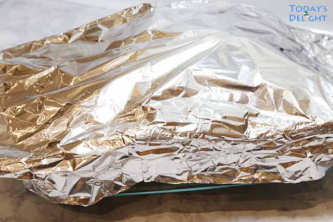 Barbecued lemon pepper ribs and pork covered with foil.