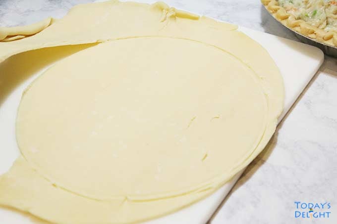 Excess dough remove from top crust pie.