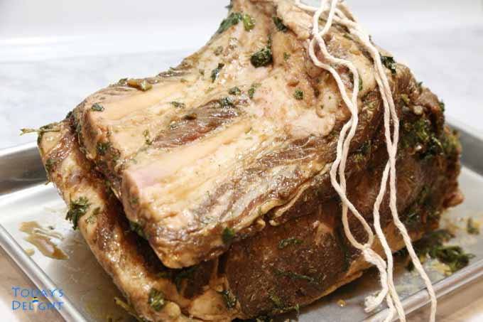 Prime rib with rib bones detached and will be tied with a twine.