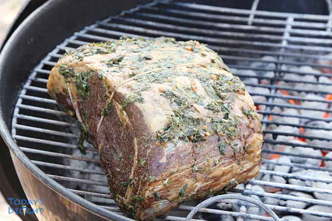 Prime rib in charcoal grill.