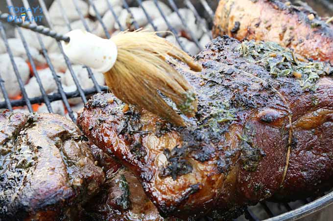 Basting grilled prime rib roast.