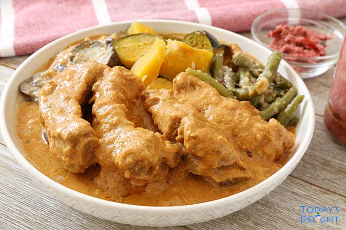 Kare-Kare with coconut milk (gata) is made of ribs and vegetables like squash, green beans, eggplant in peanut sauce and coconut milk. A side of shrimp paste is served with this dish.