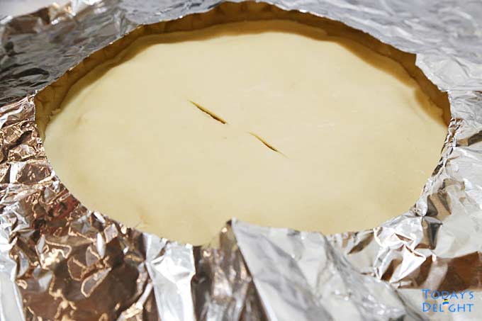 Pie Crust Shield covering edges of pie while baking.
