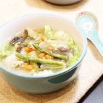 Chicken soup with Asparagus spears in a bowl.