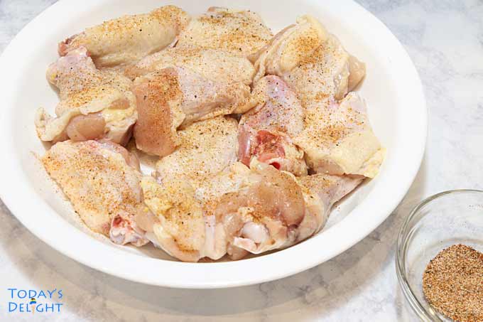 Seasoned chicken wings in a bowl.