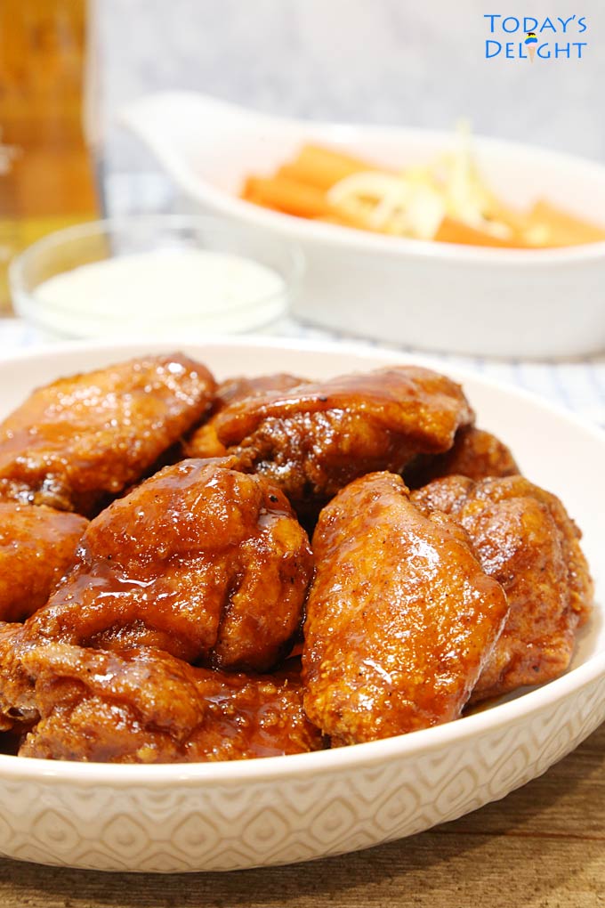 Crispy Sweet and Spicy Chicken Wings in a bowl with sides.