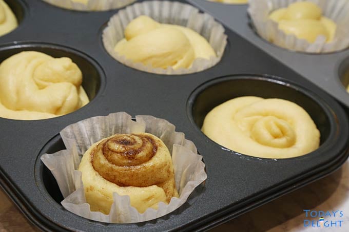 Coiled ensaymadas and one cinnamon are in molds.
