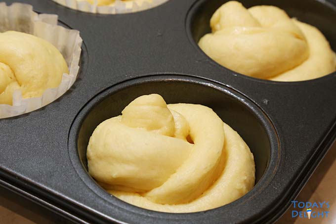 Coiled ensaymada dough placed in the molds.