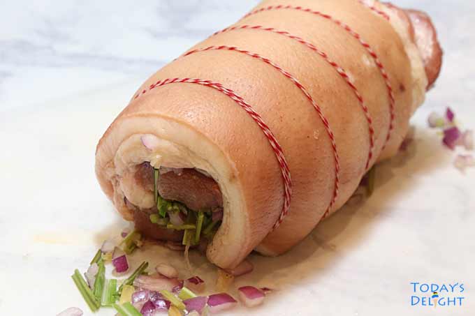 Pork belly formed into a log & secured with kitchen twine.