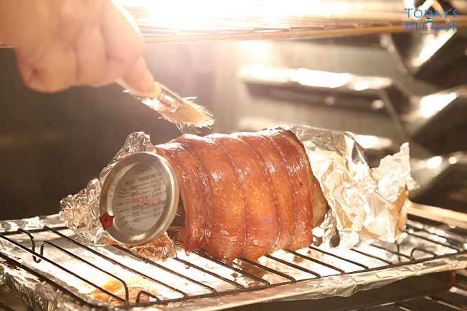 Lechon Belly Roll in oven and brush with oil.