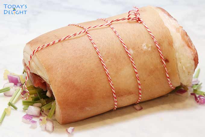 Pork belly rolled and tied with kitchen twine.