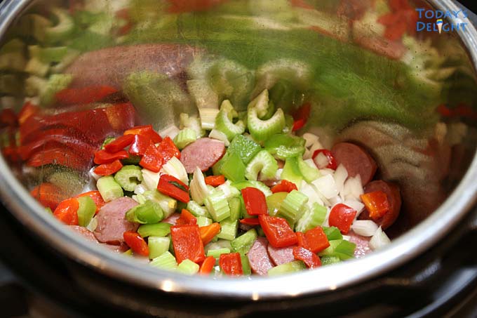 Sausage, bacon and holy trinity vegetables in instant pot.