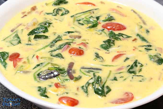 Bacon Spinach Frittata ingredients mixed in big bowl.