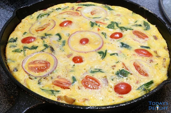 Cooked Bacon Spinach Frittata in cast iron.
