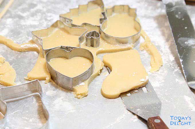 Making cut out dough with cookie cutters.