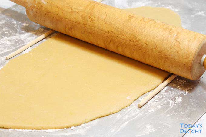 Rolled out sugar cookie with rolling pin.