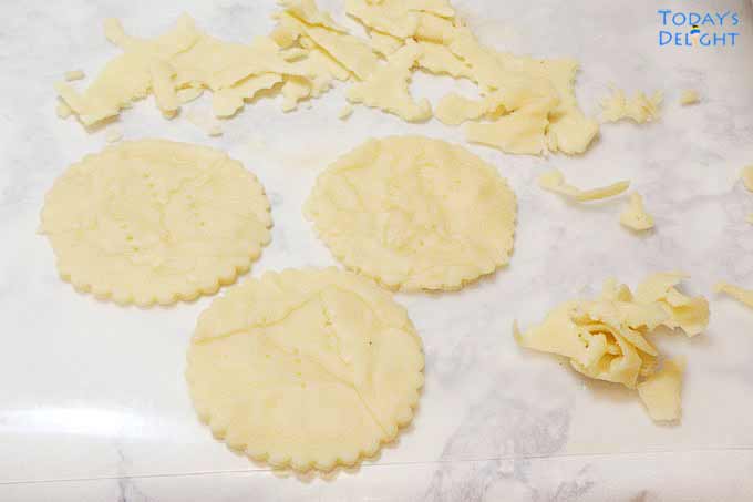 Cutout leftover dough patched together to form another mini quiche shell.