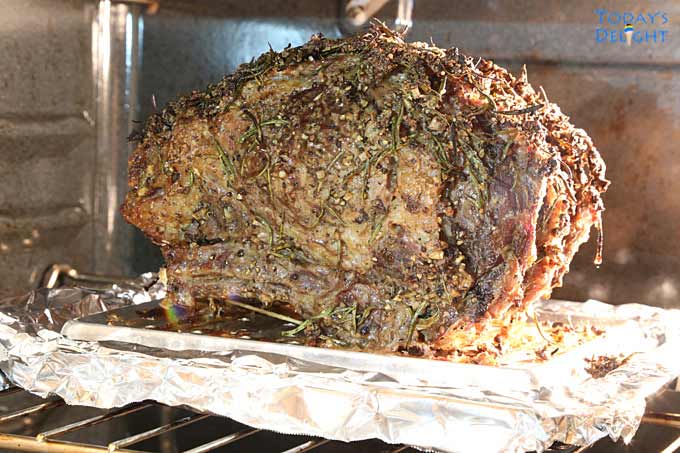 The seasoned prime rib is slowly roasted in the oven.