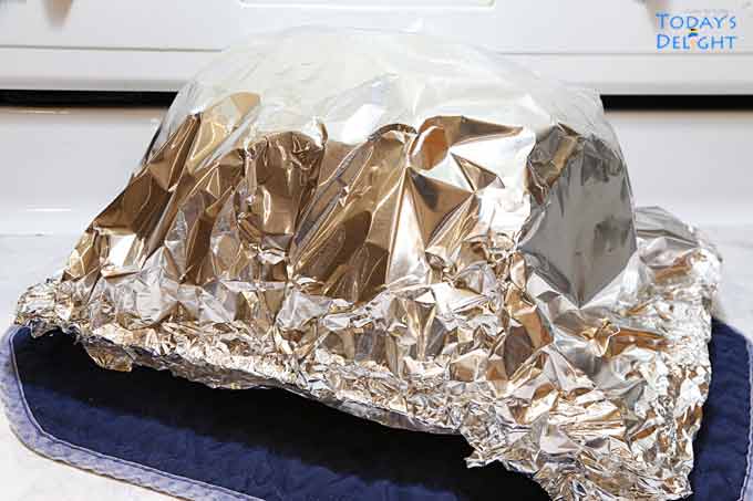 The cooked rib roast is covered with foil and resting for 10 minutes.