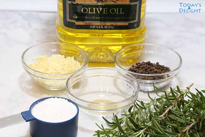 Ingredients for prime rib are olive oil, salt, garlic, thyme powder, peppercorns, and rosemary.
