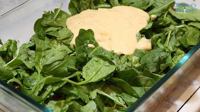 White sauce or bechamel sauce added on top of the spinach layer.