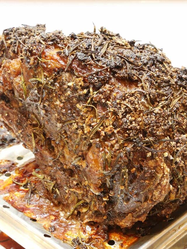 A medium-well done standing rib roast with rub on a rack