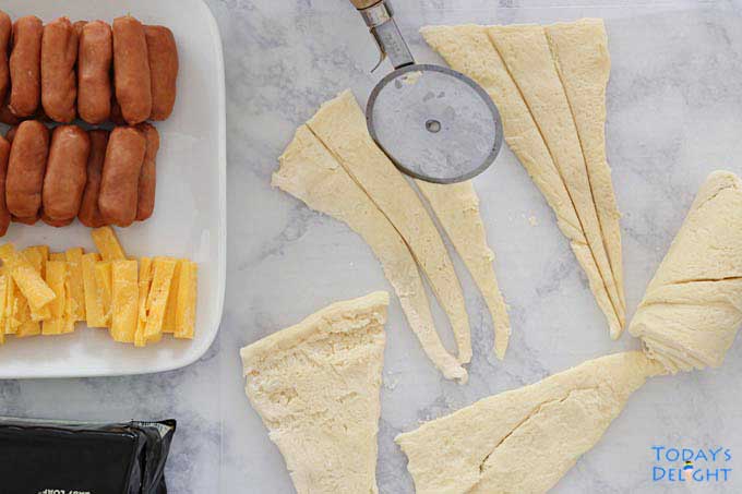 Ingredients and crescent triangles are divided into smaller pieces.