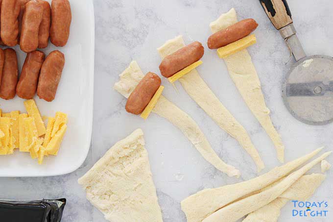 Lil' Smokies and Cheese on strip of crescent roll dough.