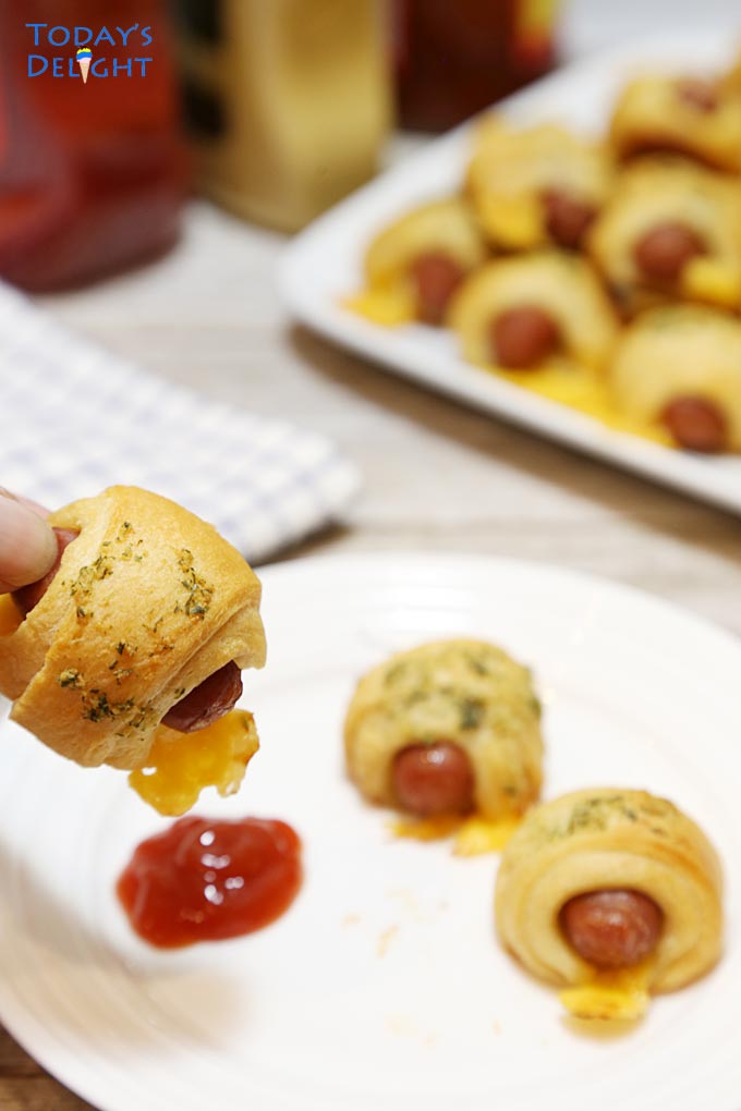Dip mini crescent dogs in ketchup.